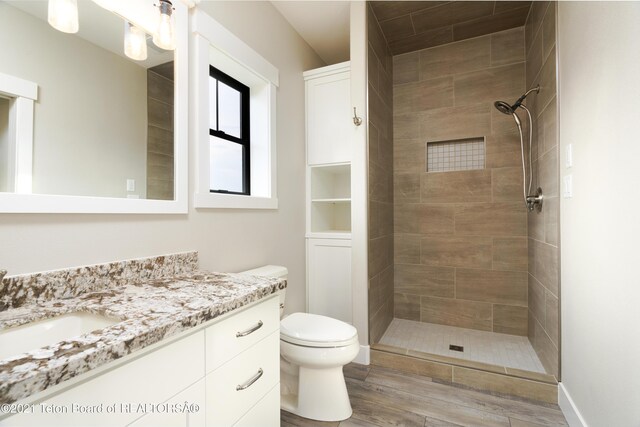 1845 S 5000 W, Driggs, ID 83422 - full bath featuring wood finished floors, a tile shower, toilet, and vanity