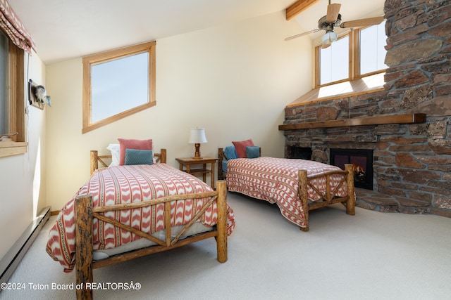 carpeted bedroom with ceiling fan, a fireplace, lofted ceiling with beams, and a baseboard heating unit