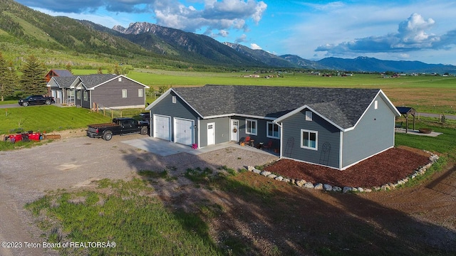 view of front facade featuring a mountain view, a garage, and a front yard