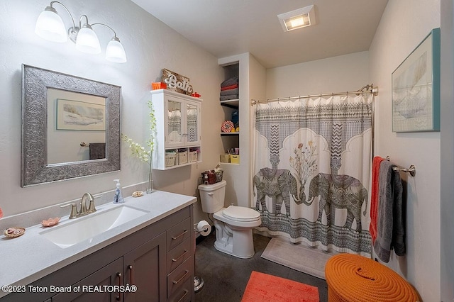 bathroom with vanity, toilet, and walk in shower