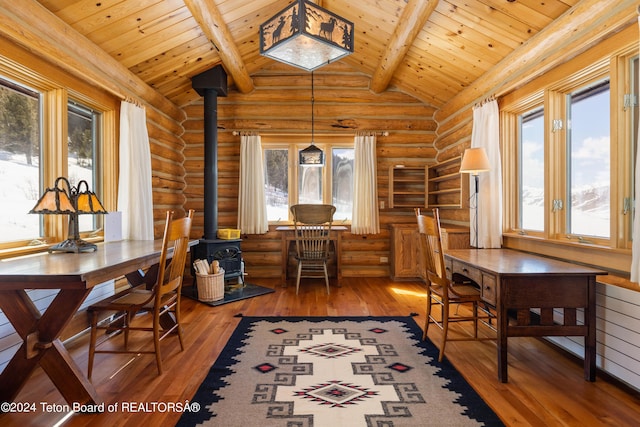 interior space with wood ceiling, beamed ceiling, rustic walls, and hardwood / wood-style flooring