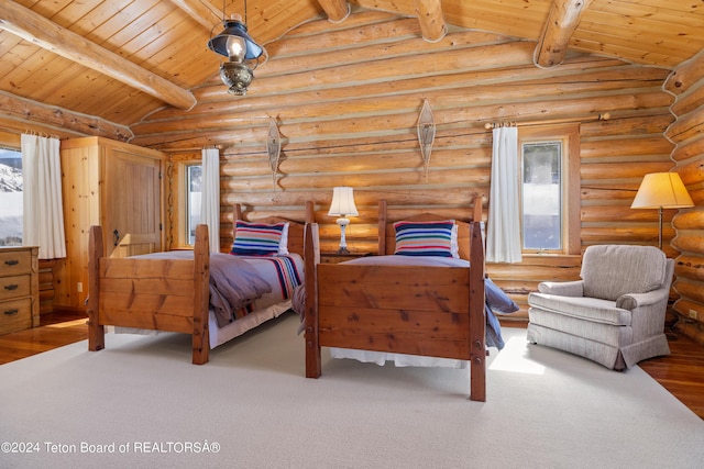 bedroom with vaulted ceiling with beams, carpet floors, wooden ceiling, and rustic walls