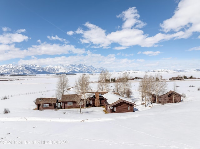 snowy aerial view with a mountain view