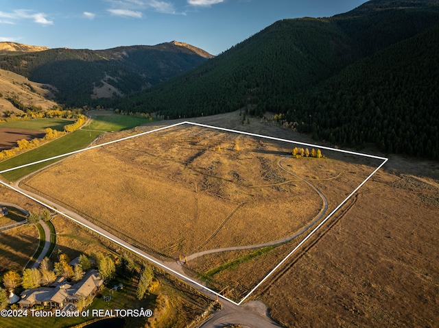 drone / aerial view featuring a rural view and a mountain view