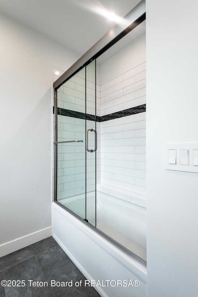 bathroom featuring bath / shower combo with glass door