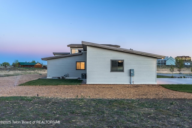 property exterior at dusk with central AC unit