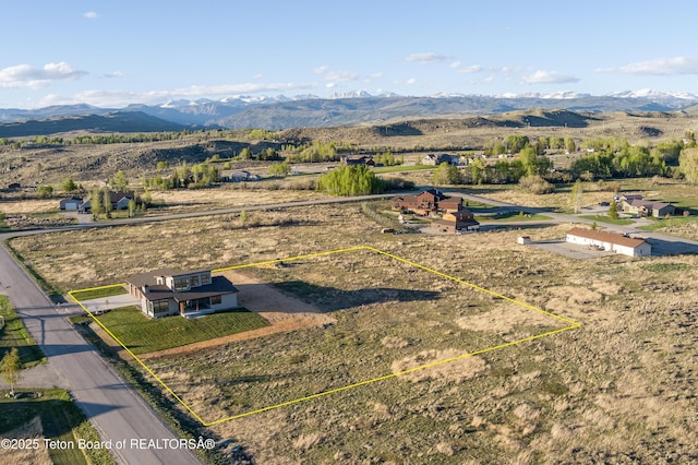 birds eye view of property with a mountain view