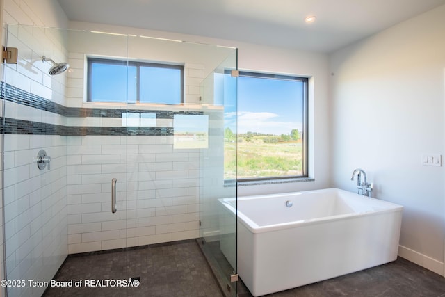 bathroom featuring independent shower and bath