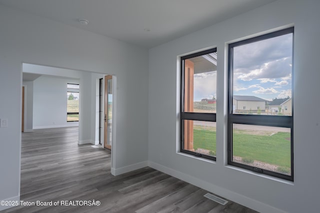 spare room with dark hardwood / wood-style floors