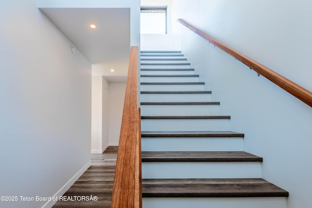 stairway featuring wood-type flooring