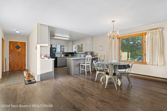 dining area with baseboard heating, dark wood-type flooring, a textured ceiling, and a chandelier