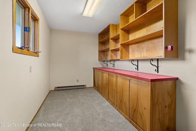 bar featuring light carpet, a textured ceiling, and a baseboard radiator