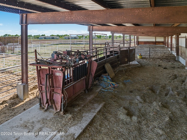 view of horse barn with a rural view