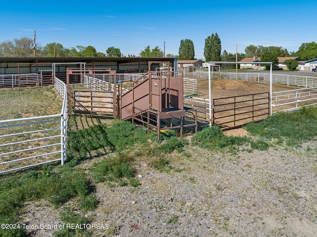 view of horse barn with a rural view