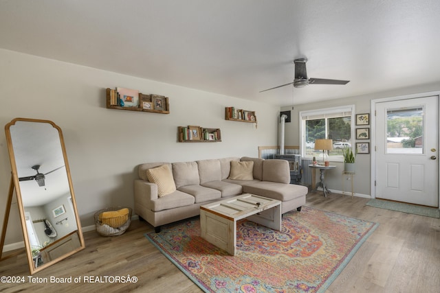 living room featuring light hardwood / wood-style flooring and ceiling fan