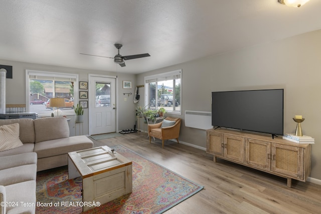 living room featuring light hardwood / wood-style floors and ceiling fan