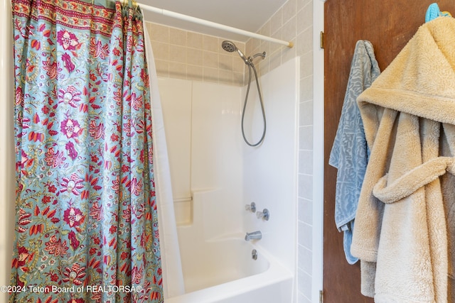 bathroom featuring shower / bathtub combination with curtain