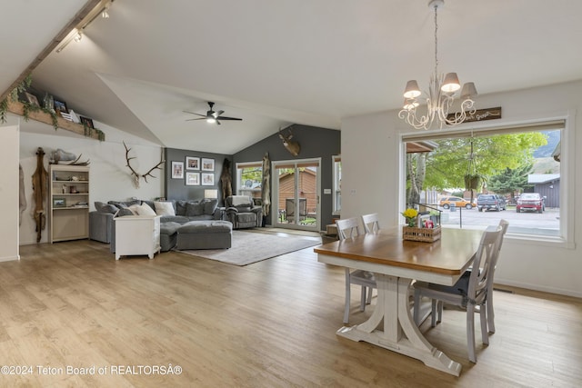 dining area with light hardwood / wood-style floors, vaulted ceiling, and plenty of natural light