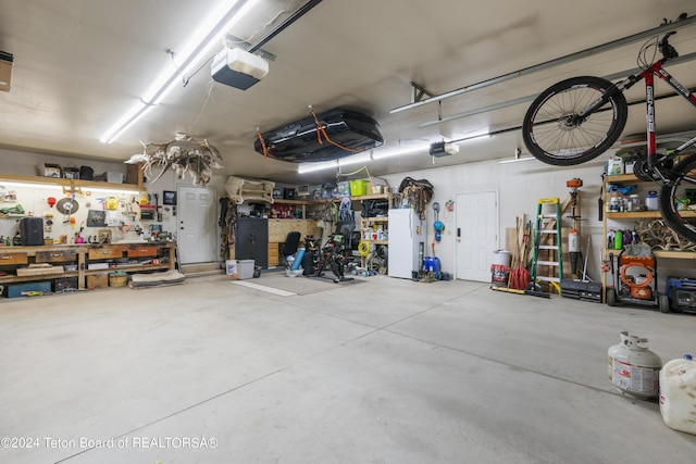 garage featuring a workshop area and a garage door opener