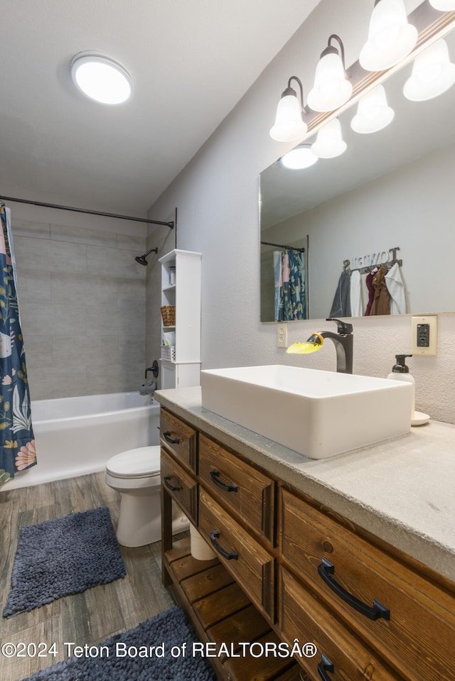 full bathroom with shower / bathtub combination with curtain, toilet, vanity, and hardwood / wood-style flooring