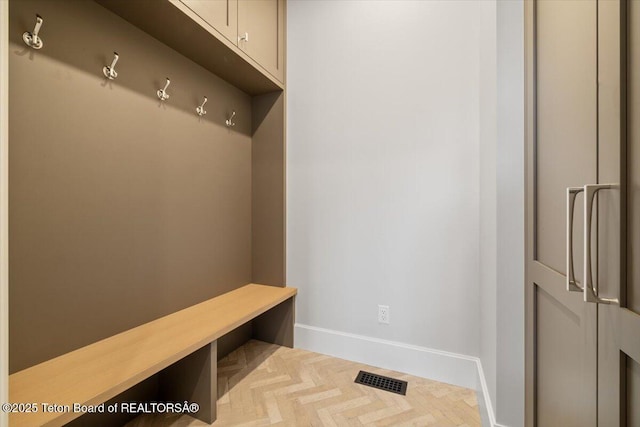 mudroom with baseboards and visible vents