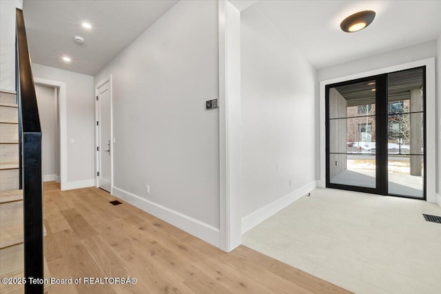 hallway with baseboards, recessed lighting, visible vents, and light wood-style floors