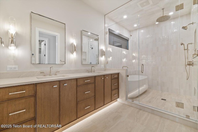 bathroom featuring a sink, a shower stall, and double vanity