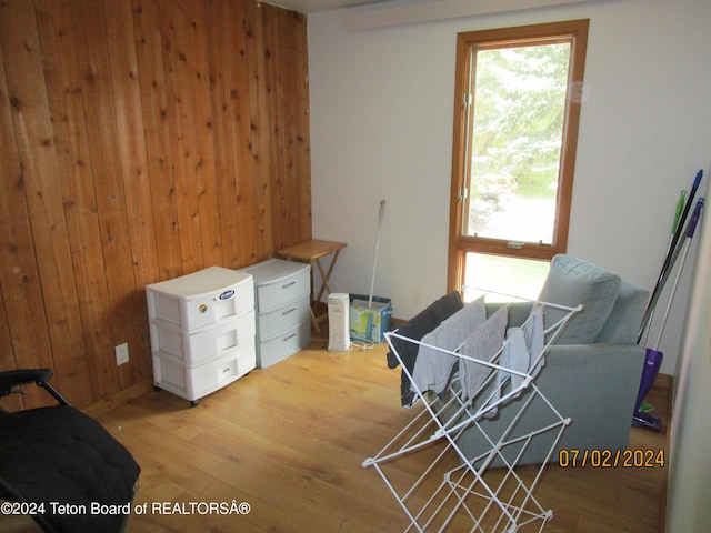 living area featuring wooden walls and light wood-type flooring