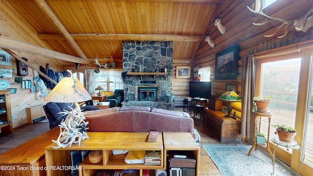 1404 Warm Springs Dr, Dubois, WY 82513 - living area with wood ceiling, hardwood / wood-style flooring, rustic walls, and a stone fireplace