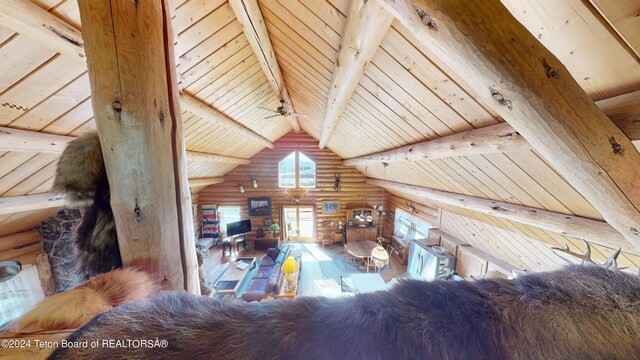 1404 Warm Springs Dr, Dubois, WY 82513 - living room with log walls, wooden ceiling with exposed beams, and high vaulted ceiling