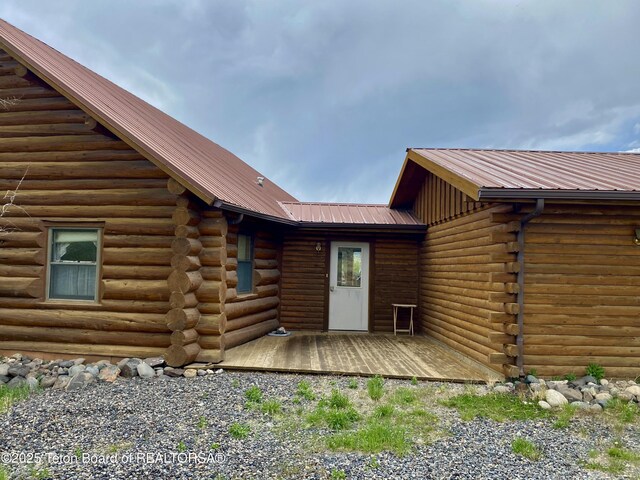 1404 Warm Springs Dr, Dubois, WY 82513 - view of exterior entry featuring log exterior, metal roof, and a deck