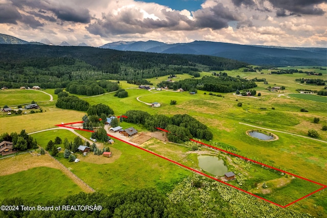 birds eye view of property with a water and mountain view and a rural view