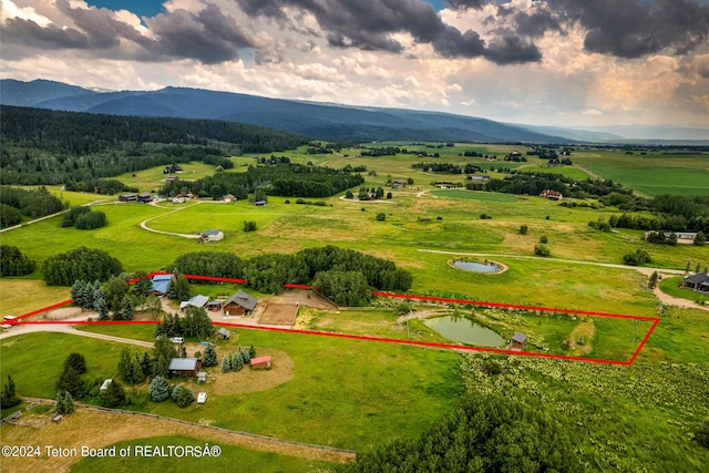 drone / aerial view with a rural view and a water and mountain view