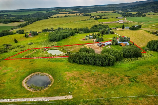 drone / aerial view featuring a water view and a rural view