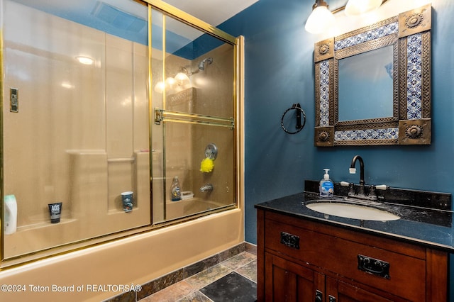bathroom with bath / shower combo with glass door and vanity