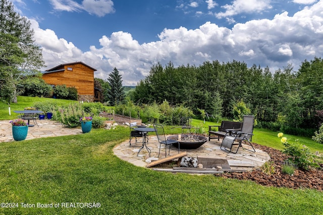 view of yard with a fire pit and a patio area