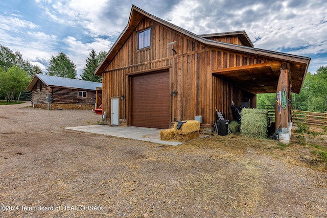 view of side of home with an outbuilding and a garage
