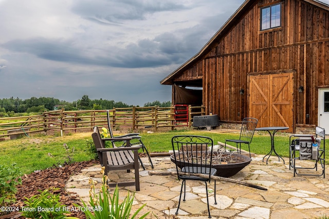view of patio / terrace with a rural view and an outdoor structure