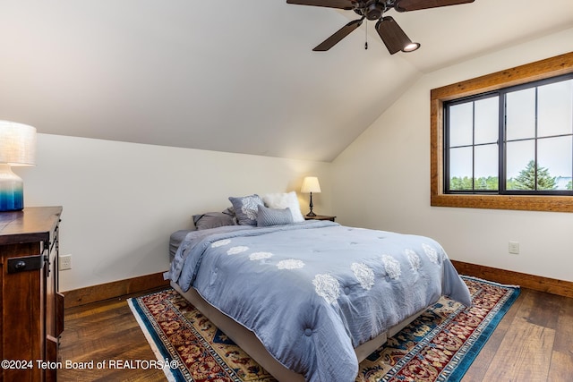 bedroom featuring dark wood-type flooring, ceiling fan, and vaulted ceiling