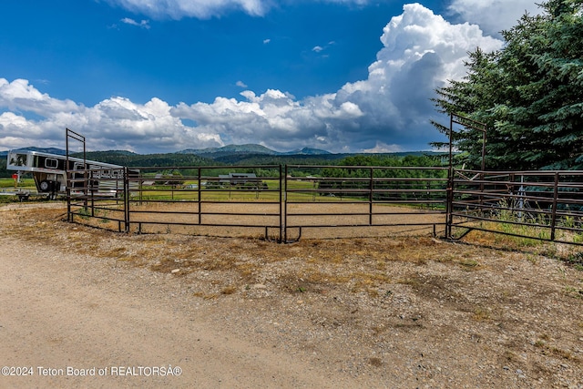 view of gate with a mountain view and a rural view