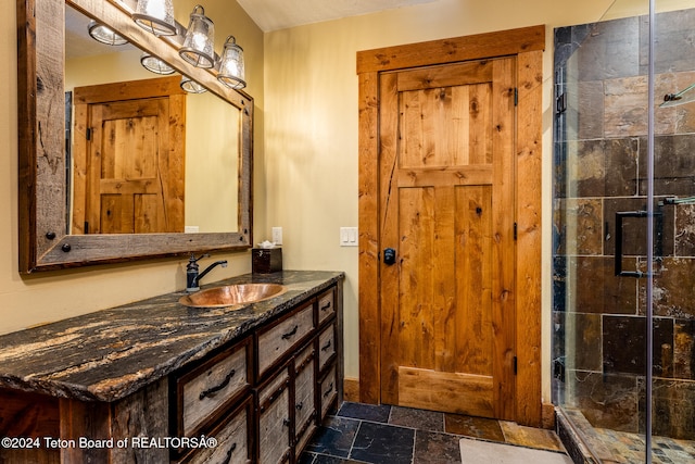 bathroom with vanity and a tile shower