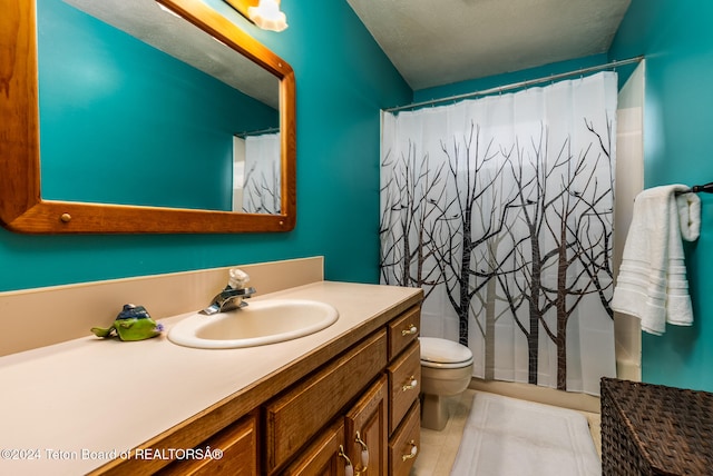 bathroom featuring tile patterned flooring, vanity, walk in shower, toilet, and a textured ceiling