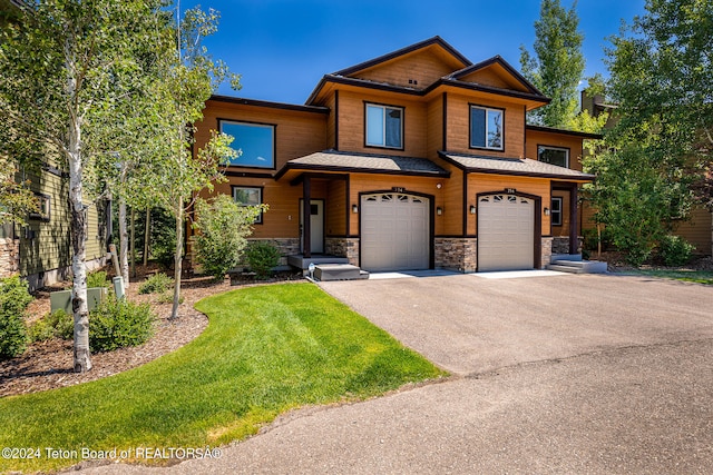 view of front of house with a garage and a front yard