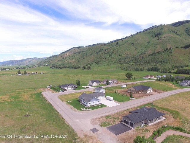 birds eye view of property with a mountain view and a rural view