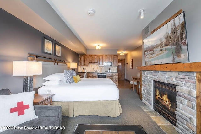 bedroom featuring a fireplace and visible vents