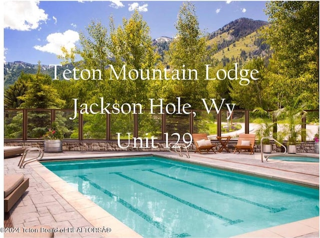 pool with a mountain view and a patio