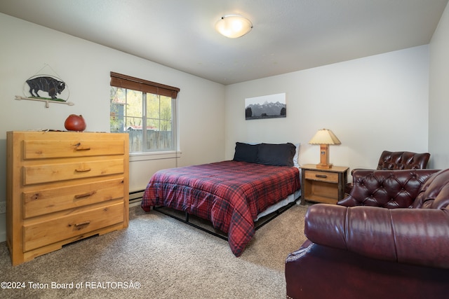 carpeted bedroom with a baseboard heating unit