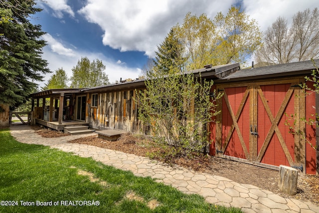 exterior space featuring a yard and a storage unit