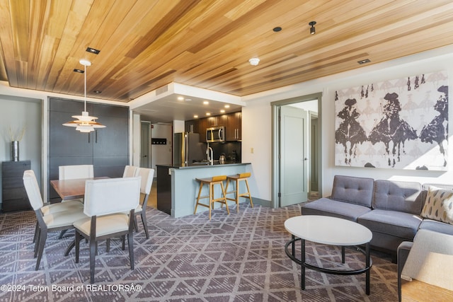 living room featuring sink and wooden ceiling