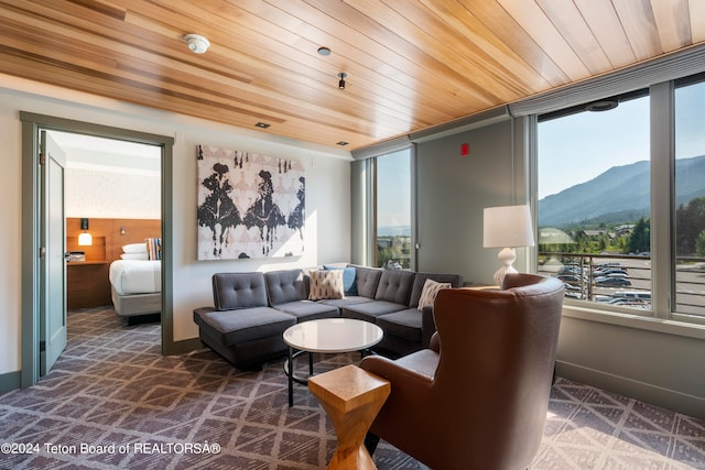 living room featuring wooden ceiling and a mountain view